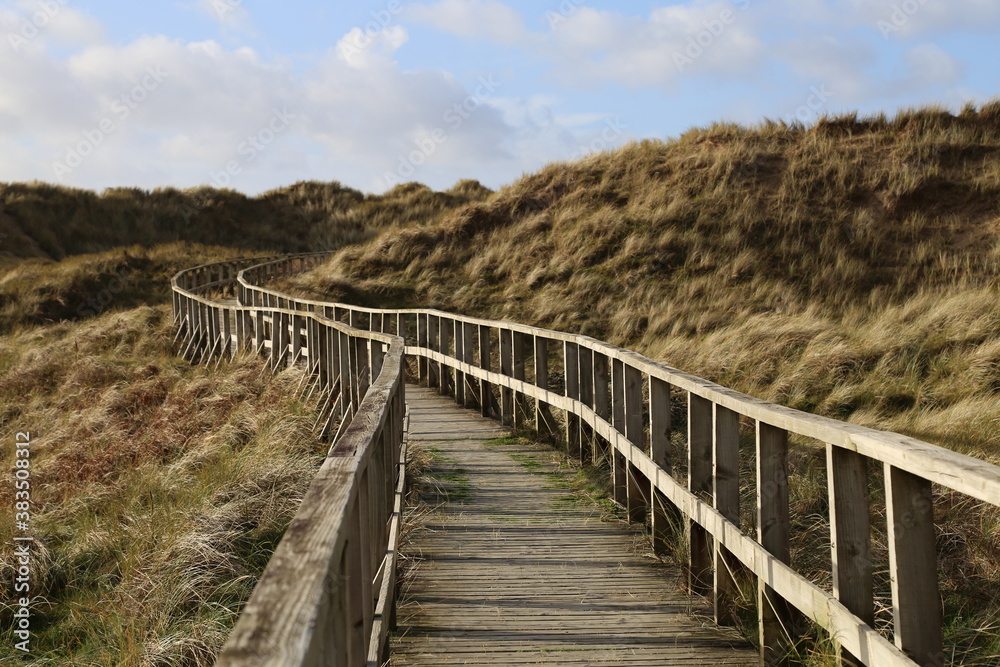 The wooden boardwalk leading through the dunes to the beach at Dyffryn Ardudwy, Gwynedd, Wales, UK.