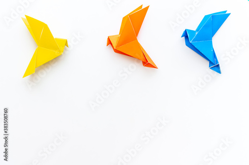 Origami birds are flying  overhead top view