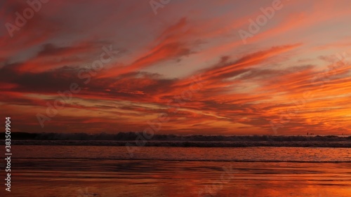 California summertime beach aesthetic, golden sunset. Vivid dramatic clouds over pacific ocean waves. Santa Monica popular resort, Los Angeles CA USA. Atmospheric moody purple evening sundown in LA © Dogora Sun