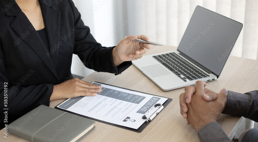 HR head is interviewing a young man's job application in a private room. HR head is interviewing a young man's job application in a private room.