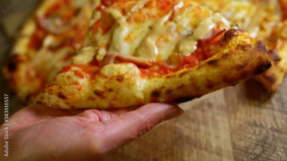 Female hand putting a slice of bbq pizza. Female hand putting a slice of bbq pizza.
