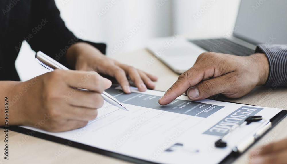 HR head is interviewing a young man's job application in a private room. HR head is interviewing a young man's job application in a private room.