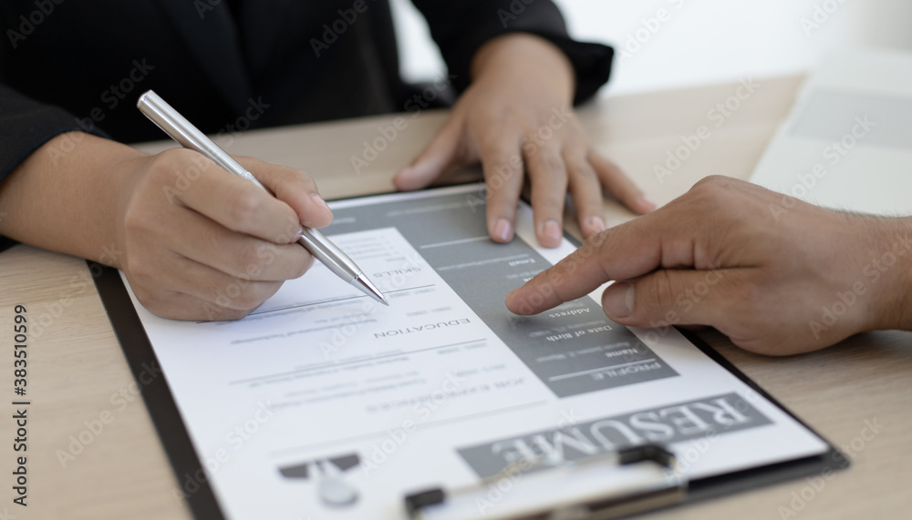HR head is interviewing a young man's job application in a private room. HR head is interviewing a young man's job application in a private room.