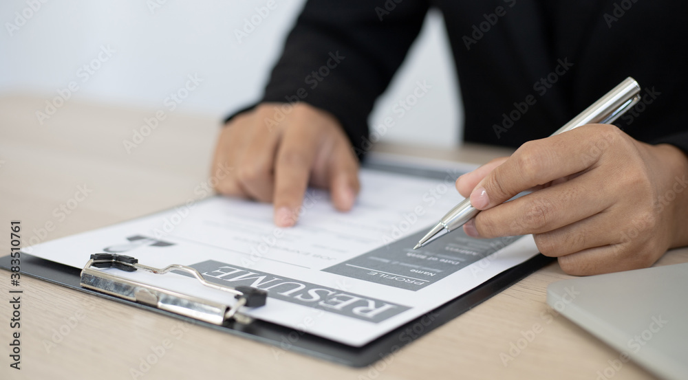 HR head is interviewing a young man's job application in a private room. HR head is interviewing a young man's job application in a private room.
