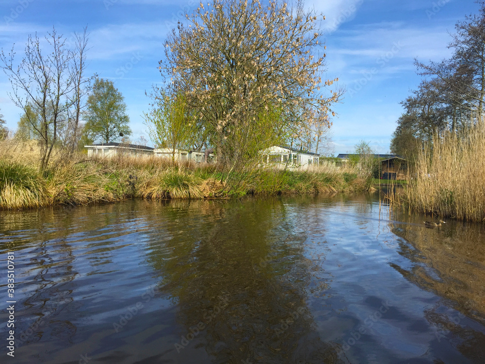 landscape with river and sky in the village of Giethoorn, Holland Netherlands landscape with river and sky in the village of Giethoorn, Holland Netherlands