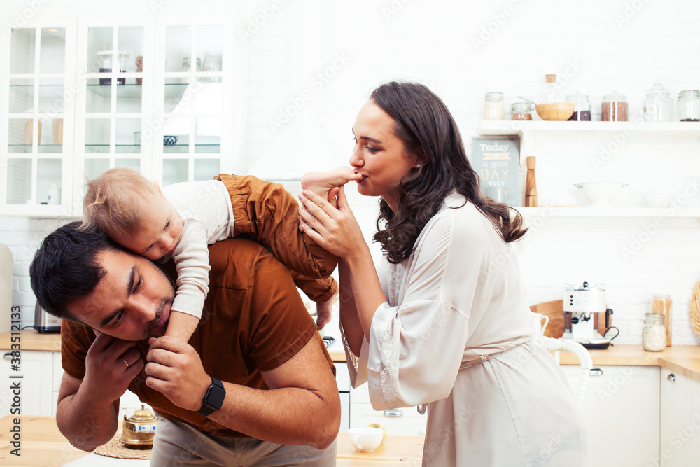 young family with little cute son on kitchen in morning happy smiling, lifestyle people concept young family with little cute son on kitchen in morning happy smiling, lifestyle people concept