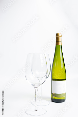 Bottle of white wine and glasses isolated on white