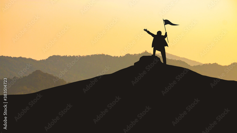 Success concept, Silhouette of businessman holding a flag of victory on the top of the hill