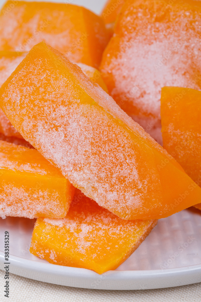 Frozen pieces of pumpkin on the plate. Frozen pieces of pumpkin on the plate.