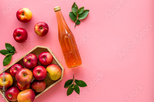 Apple cider vinegar in bottle with fruits top view photo