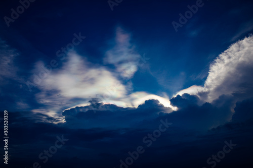 Blue sky and iridescent clouds background © Nattawat