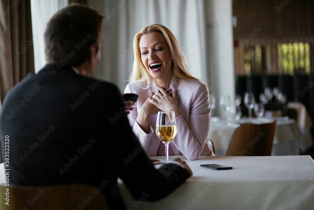 Beautiful businesswoman dressed in the suit drinking wine. Businesswoman enjoying in the restaurant...