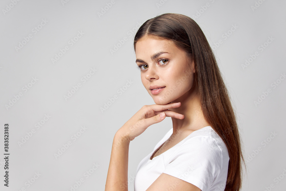Woman holds hand near chin long hair beautiful face Woman holds hand near chin long hair beautiful face