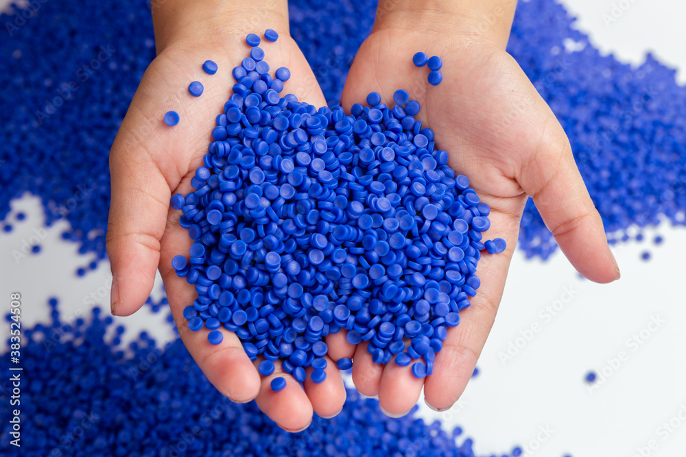Close-up of plastic polymer granules. hand hold Polymer pellets. polymer plastic. compound polymer. Close-up of plastic polymer granules. hand hold Polymer pellets. polymer plastic. compound polymer.