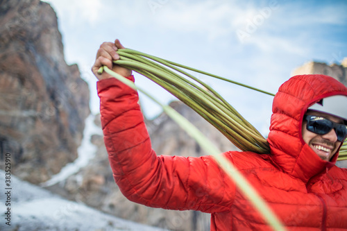 Climber coils rope after a successful climb photo