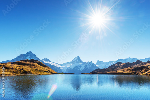 Fototapeta Naklejka Na Ścianę i Meble -  Bachalpsee lake in Swiss Alps mountains. Snowy peaks of Wetterhorn, Mittelhorn and Rosenhorn on background. Grindelwald valley, Switzerland. Landscape photography