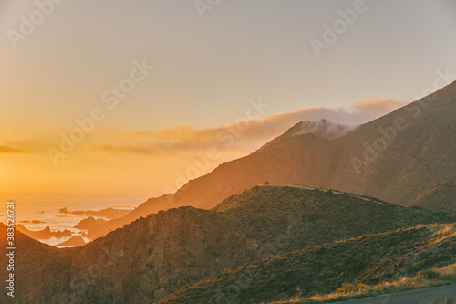 Misty sunset over cliffs of Pacific Ocean in Baja, Mexico.
