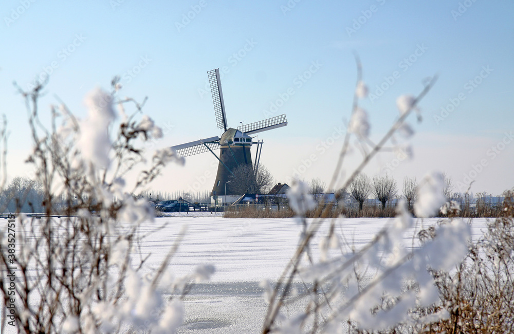 Windmill in Netherlands winter landscape Windmill in Netherlands winter landscape
