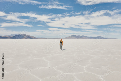 Young woman exploring Bonneville Salt Flats during a summer road trip.