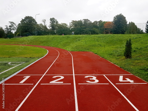 Red running racetrack on the stadium. Red running tracks in the stadium. Empty sport stadium. Starting Line of Track Running Lanes in stadium