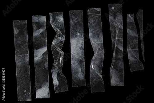 Foto set of transparent adhesive tape or strips isolated on black background, crumpled plastic sticky snips with smudgy fingerprints, poster design overlays or elements