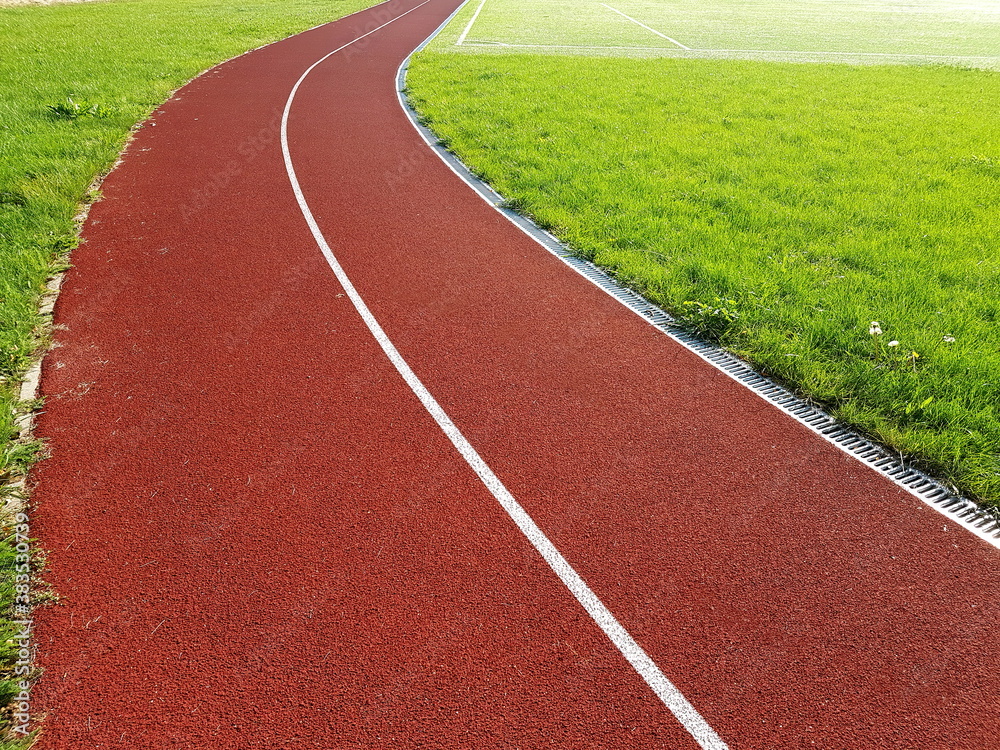 Red treadmill with white lines in a sports stadium. Red running tracks in the stadium. Empty sport stadium. Red treadmill with white lines in a sports stadium. Red running tracks in the stadium. Empty sport stadium.