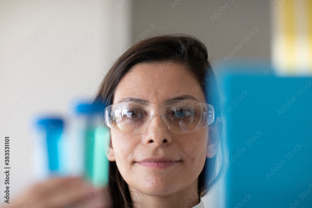 scientist female with lab glasses and sample in a lab scientist female with lab glasses and sample in a lab