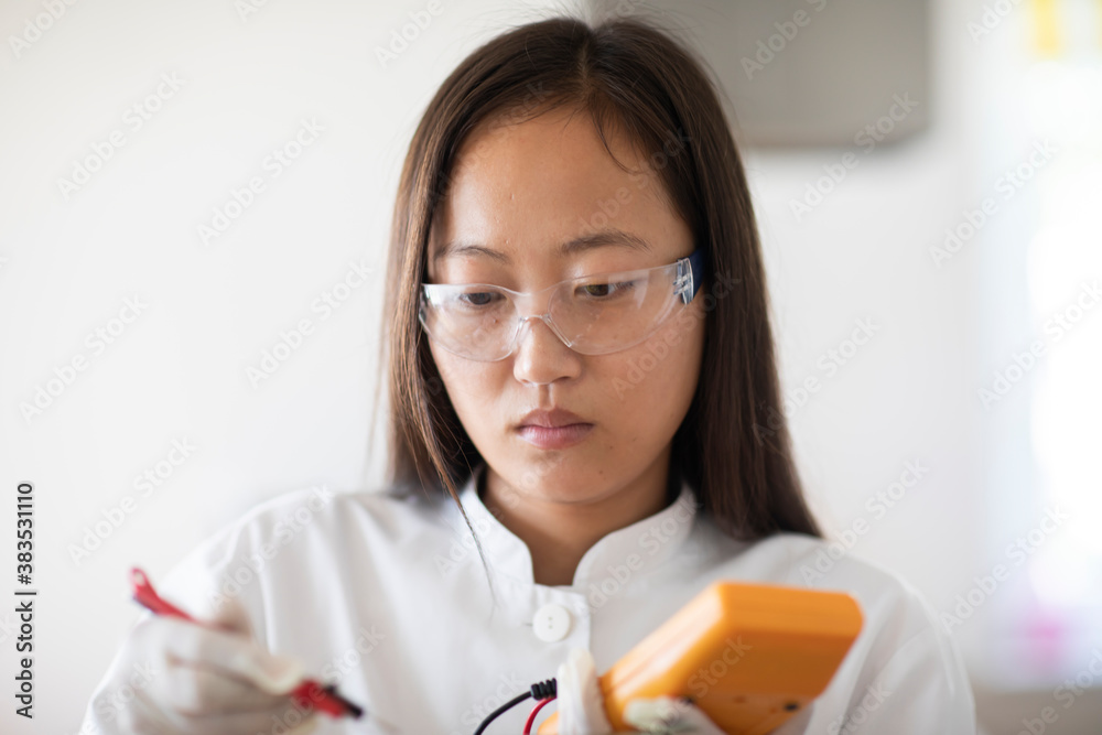 scientist female with sample and tool in a lab scientist female with sample and tool in a lab