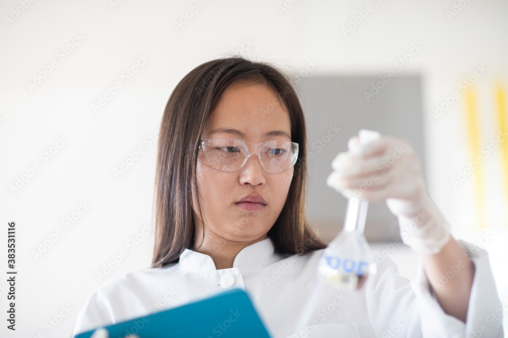 scientist female with lab glasses and tablet in a lab scientist female with lab glasses and tablet in a lab