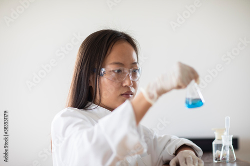 scientist female with sample and tubes in a lab photo
