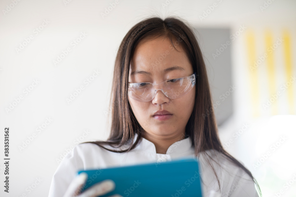 scientist female with lab glasses and tablet in a lab scientist female with lab glasses and tablet in a lab
