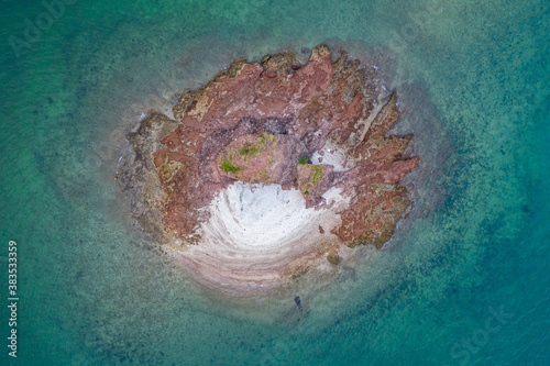 Fototapeta Naklejka Na Ścianę i Meble -  Aerial view of tiny rocky island in sea