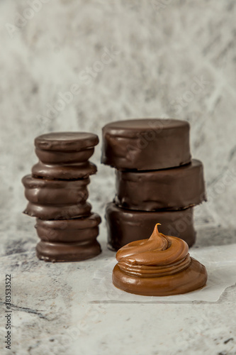 Homemade chocolate alfajores, typical of Argentina, marble background with copy space