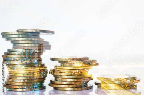 Double exposure of city background and rows of coins. business financial for investment and banking concept.