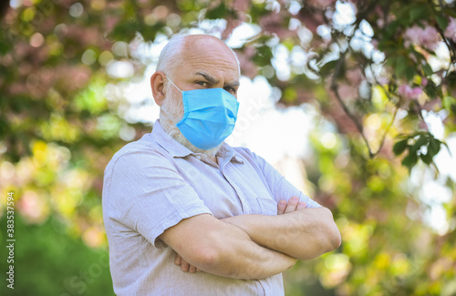 Elderly and other risk groups. Pandemic concept. Limit risk infection spreading. Senior man wearing face mask. Older people at highest risk from covid-19. Mask protecting from virus. Wear mask