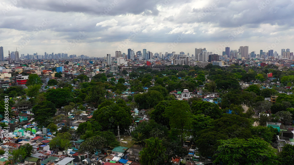 Aerial view of panorama of Manila North Cemetery with skyscrapers and business centers in a big city. Travel vacation concept Aerial view of panorama of Manila North Cemetery with skyscrapers and business centers in a big city. Travel vacation concept