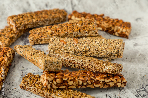 Super food breakfast Granola bars with Oats, Almonds, Pumpkin seeds, Flax seeds, Honey and Dates. flat lay on textured background with ingredients. with copy space.