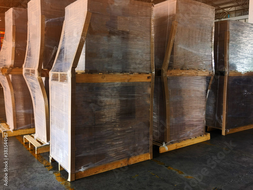 Worker driving forklift loading shipment carton boxes goods on wooden pallet at loading dock from container truck to warehouse cargo storage in freight logistics  transportation industrial  delivery