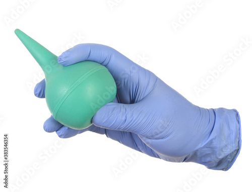 Hand in medical glove hold clyster.