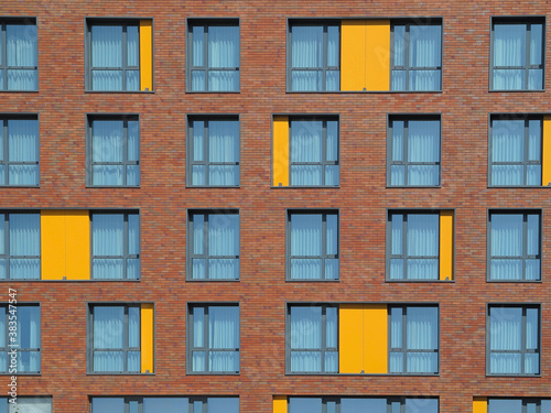Abstract brown and yellow brick facade with windows