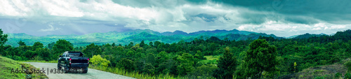 Panorama view of travelling on green mountain road with raining, Holiday activity, Beautiful landscape mountain in Thailand © Nuttapon