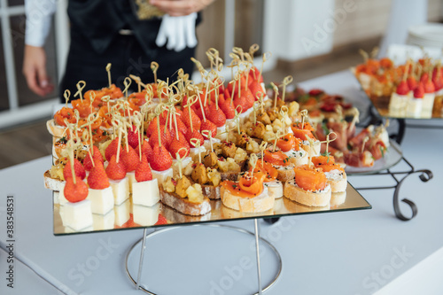 Sandwiches, canapes and cakes on the festive table. A wide variety of snacks