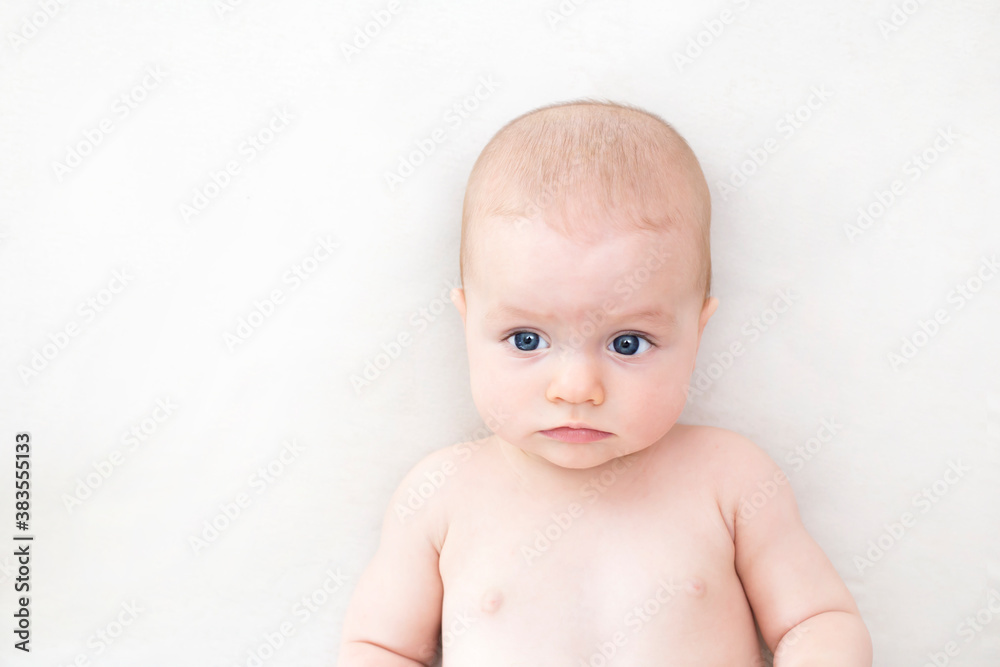 Cute baby girl lying on bed