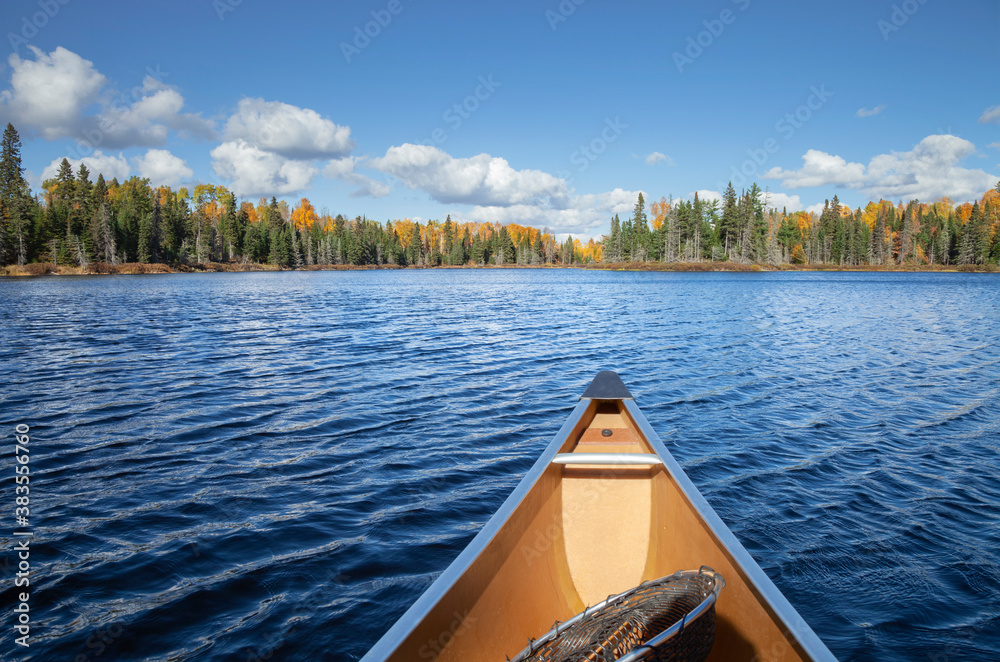 Canoe on a blue lake in northern Minnesota during autumn