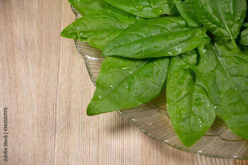 Fresh spinach leaves on wooden background