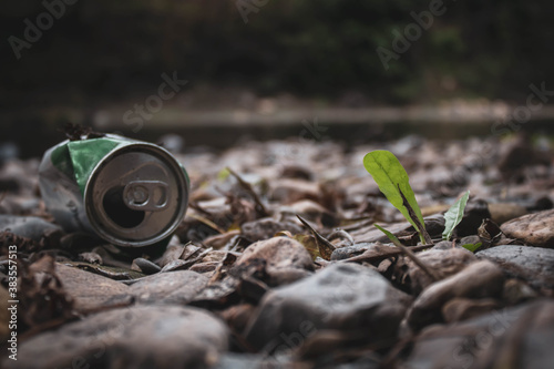 soda can leftover river side in nature