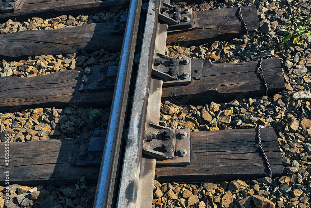 Single rail as part of a railway. Wooden sleepers and gravel are also visible. Single rail as part of a railway. Wooden sleepers and gravel are also visible.