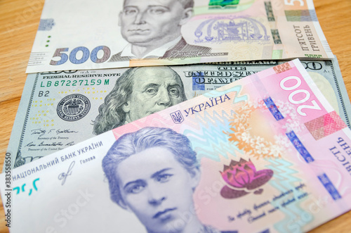 Banknote of 100 American dollars and 200, 500 Ukrainian hryvnia. The ratio of the hryvnia to the dollar. Exchange rates.