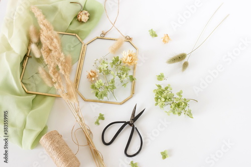 Dried flowers and herbs for making decoration flat lay on white background. Framing dried plants. Top view. Copy space.Hobby handmade with flowers.