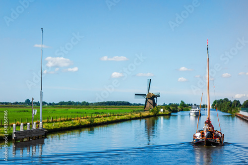 Landscape with tradional windmill, passing ships and observation camera 